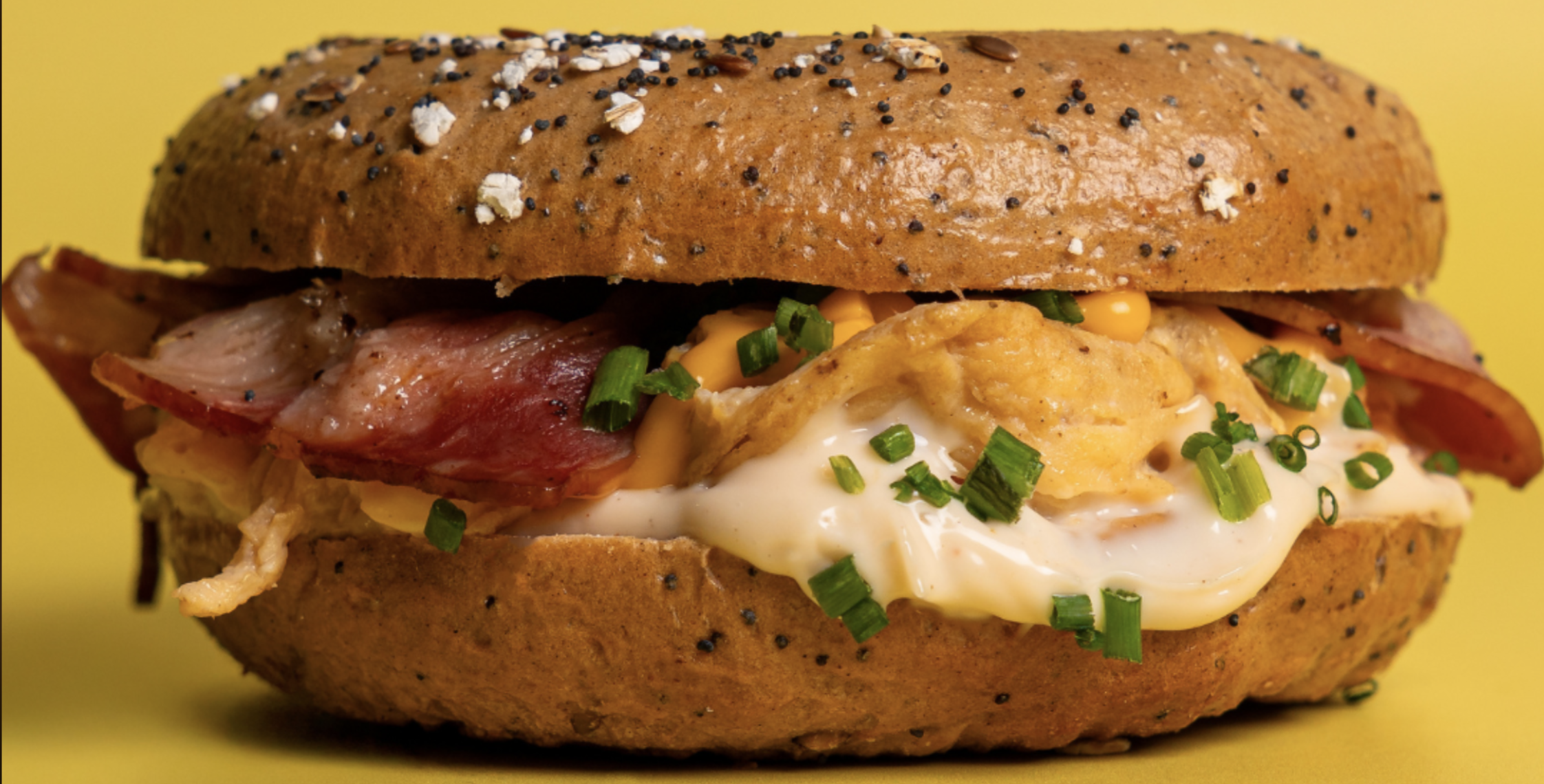 An image of one of our breakfast bagels with bacon, egg and cheese.